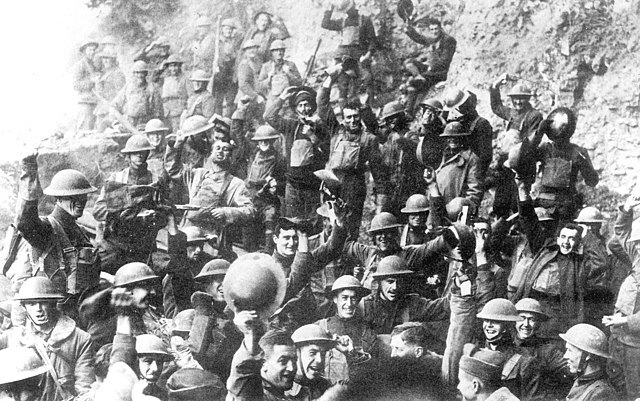 Men of US 64th Regiment, 7th Infantry Division, celebrate the news of the Armistice, 11 November 1918.