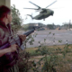 U.S. Marine provides security as American helicopters land at the DAO compound 1975